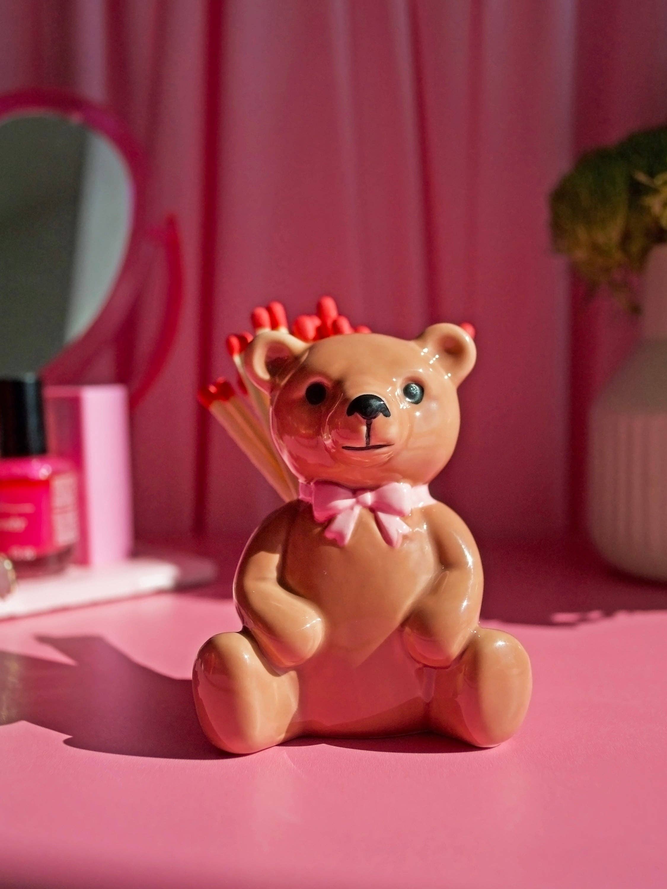 Ceramic bear match striker holding wooden matches cute and functional gift item.